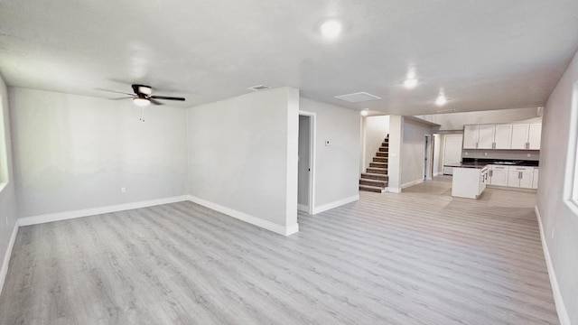 unfurnished living room featuring light hardwood / wood-style floors and ceiling fan