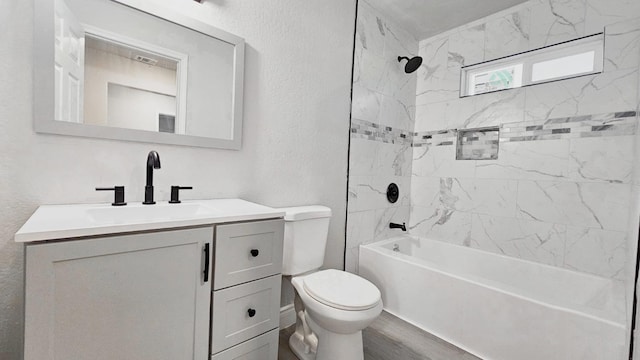 full bathroom with wood-type flooring, vanity, toilet, and tiled shower / bath