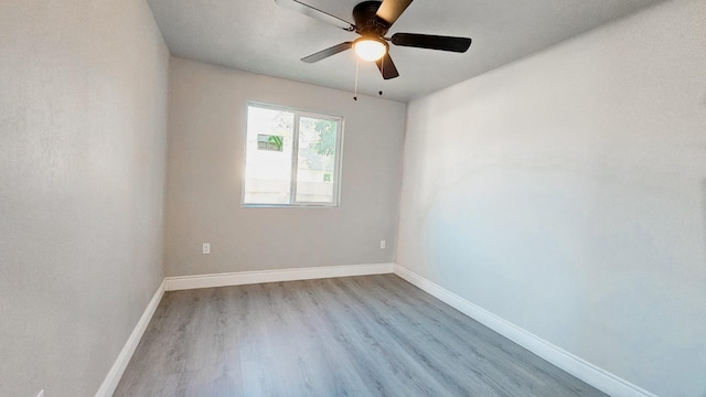 spare room with light hardwood / wood-style flooring and ceiling fan