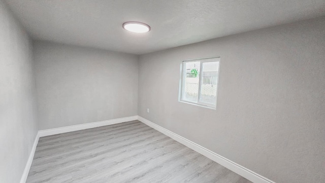 spare room with light hardwood / wood-style floors