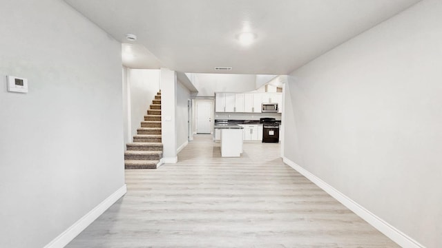 corridor with light hardwood / wood-style flooring