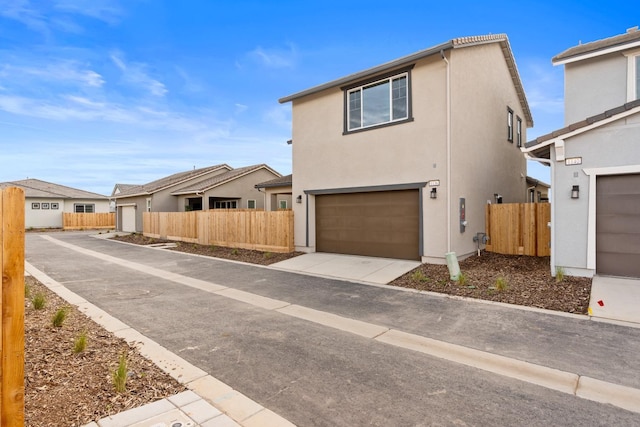 view of front of home featuring fence and stucco siding