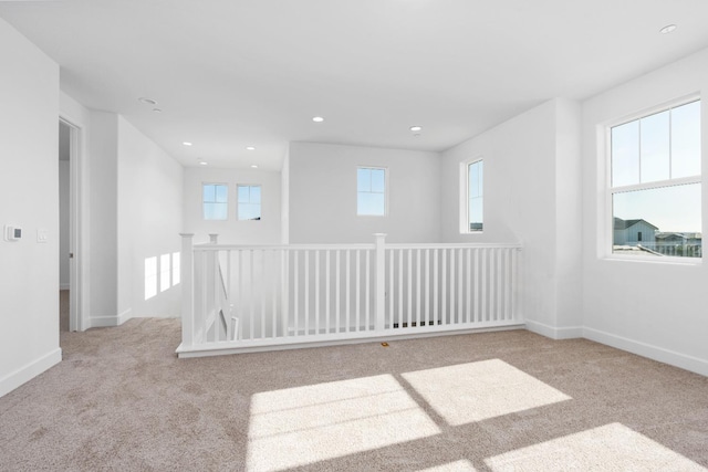 carpeted empty room with recessed lighting and baseboards