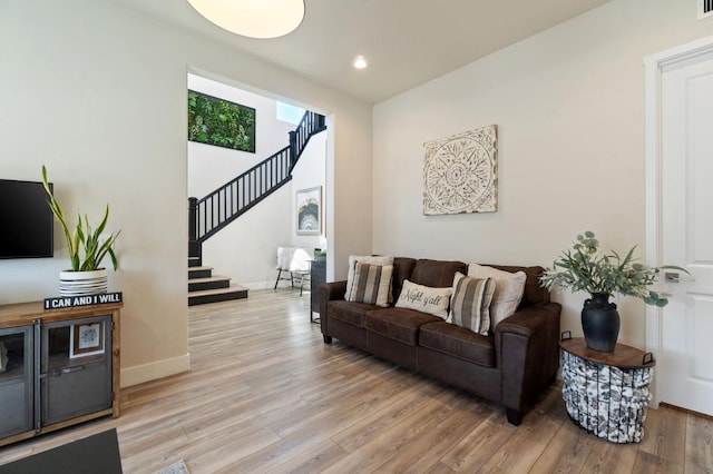 1007 Highland Rd W, Madera, CA 93636 - living room featuring stairs, light wood finished floors, baseboards, and recessed lighting