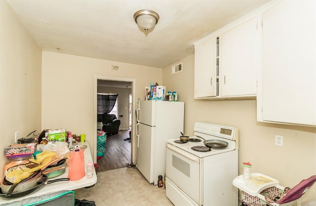 kitchen with white cabinets, white appliances, and light hardwood / wood-style floors