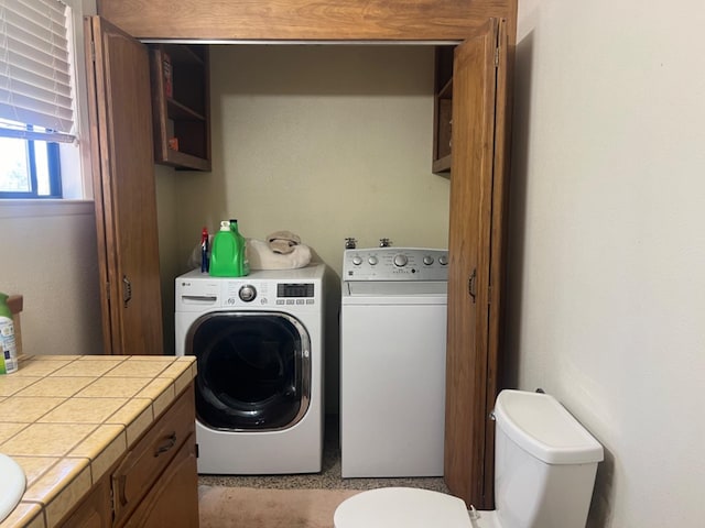 laundry room with washing machine and clothes dryer