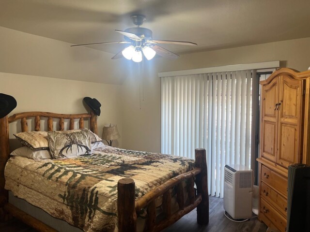 bedroom featuring ceiling fan and dark wood-type flooring