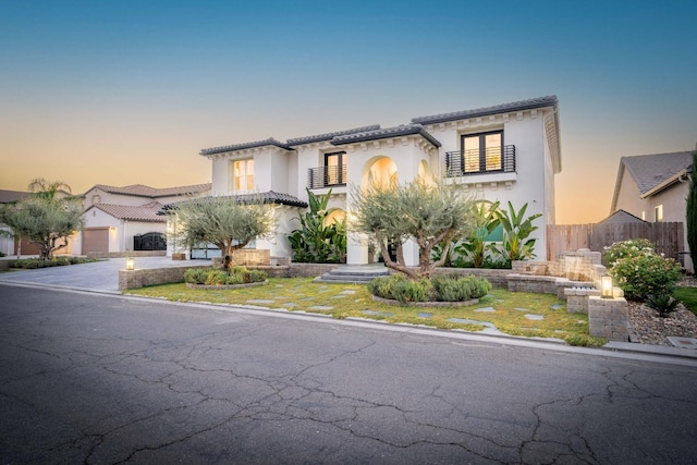 mediterranean / spanish-style house with a garage