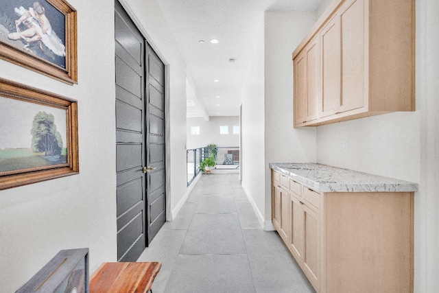 hall featuring light tile patterned floors