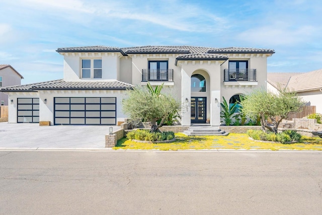 mediterranean / spanish-style house with a balcony and a garage