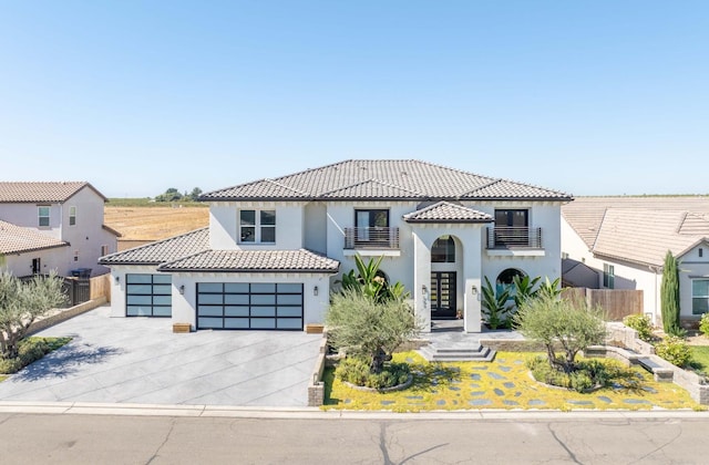 mediterranean / spanish-style home featuring a balcony and a garage