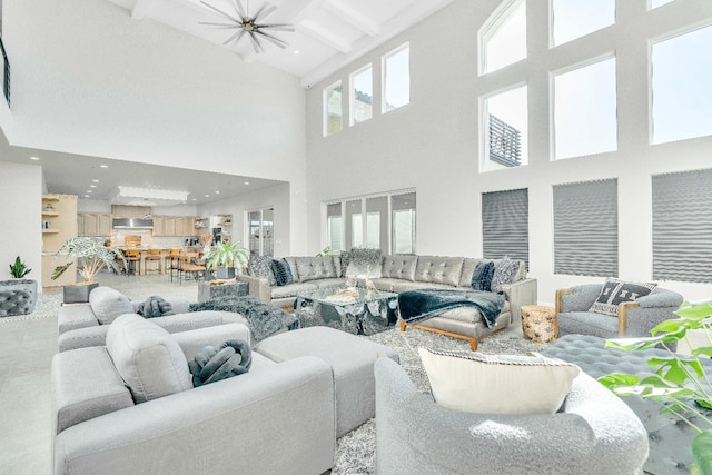 living room featuring a towering ceiling and beamed ceiling