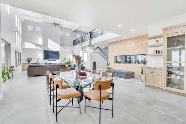 dining room featuring beam ceiling and ceiling fan