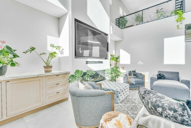 living room featuring a towering ceiling and light tile patterned floors