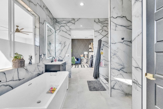 bathroom featuring tile walls, ceiling fan, independent shower and bath, and vanity