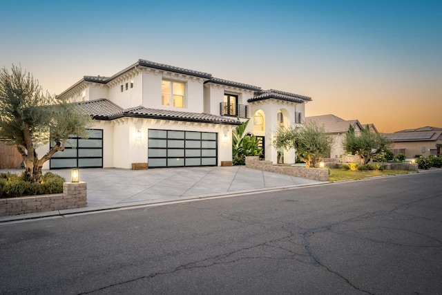 mediterranean / spanish-style house with a garage