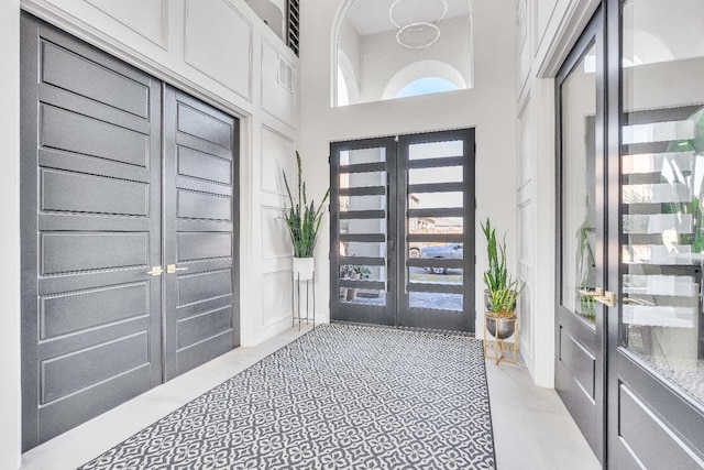 foyer featuring a high ceiling and french doors