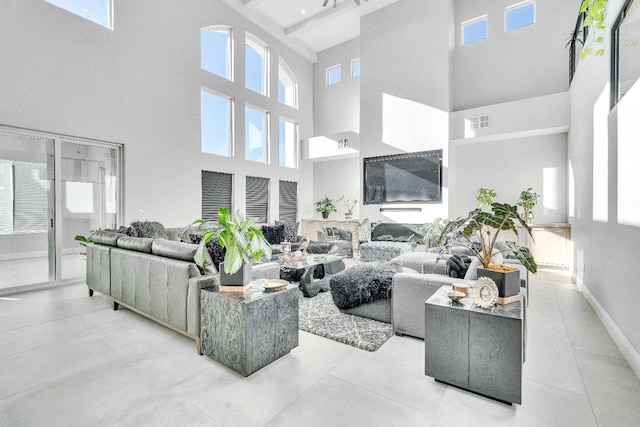 tiled living room with a towering ceiling and a wealth of natural light