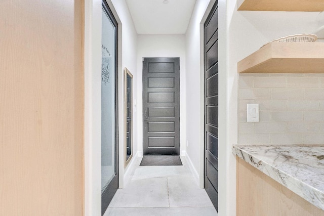 corridor with light tile patterned flooring