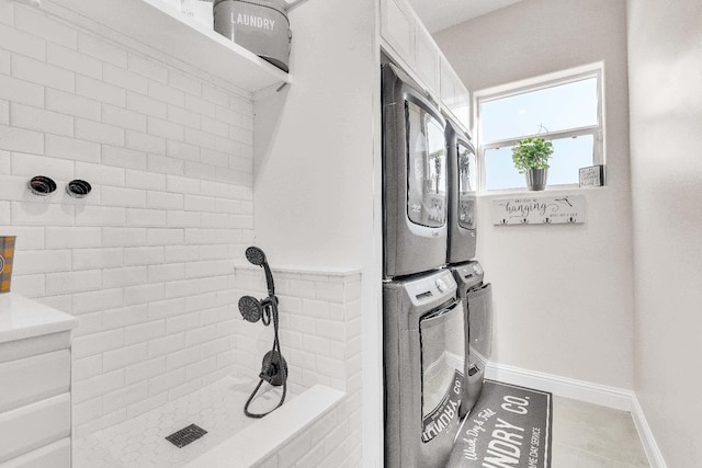 clothes washing area featuring stacked washer and dryer and light tile patterned floors