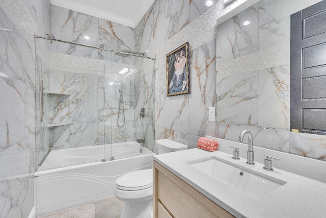 full bathroom featuring tile walls, vanity, tiled shower / bath combo, ornamental molding, and toilet