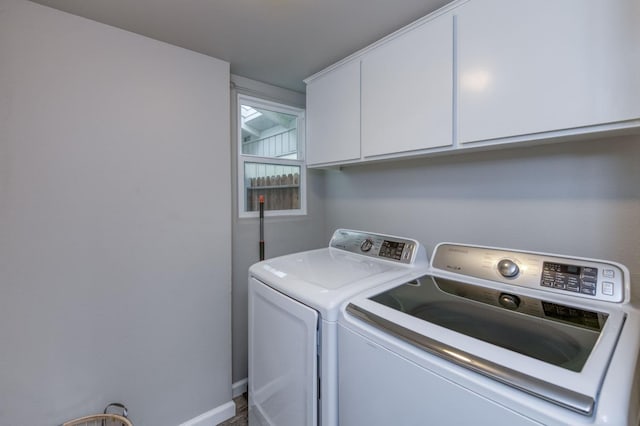 laundry room with cabinets and washing machine and dryer