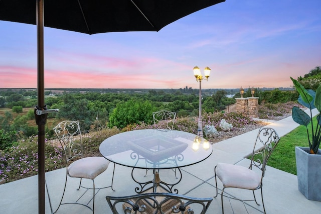 view of patio terrace at dusk