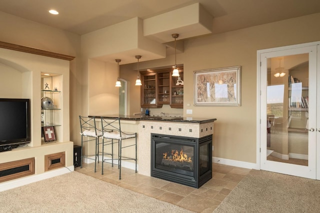 living room featuring built in shelves, light colored carpet, and a multi sided fireplace