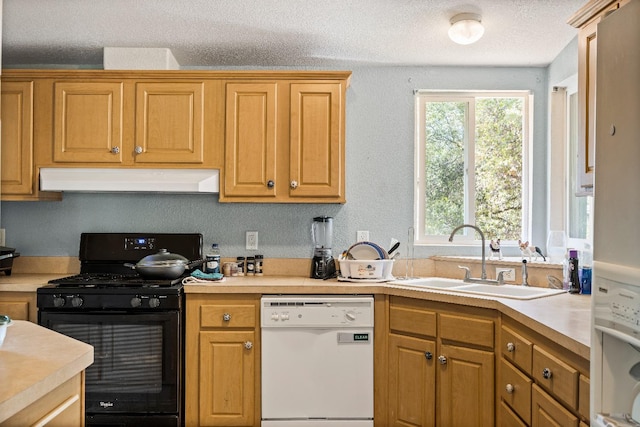 kitchen featuring white dishwasher, a textured ceiling, sink, and black gas range oven