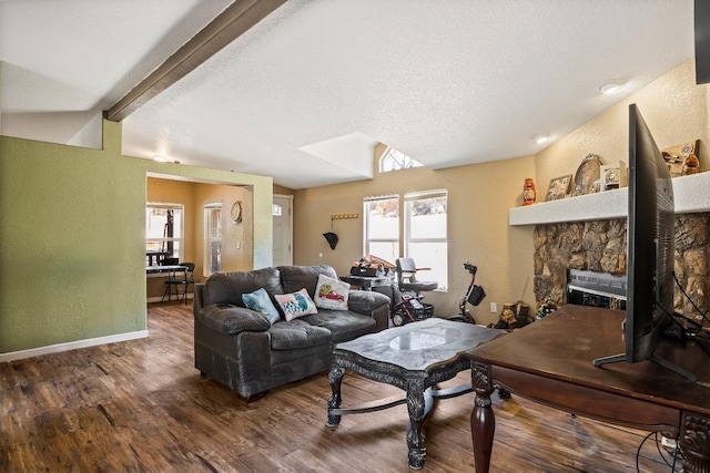 living room with a textured ceiling, a fireplace, and dark hardwood / wood-style floors