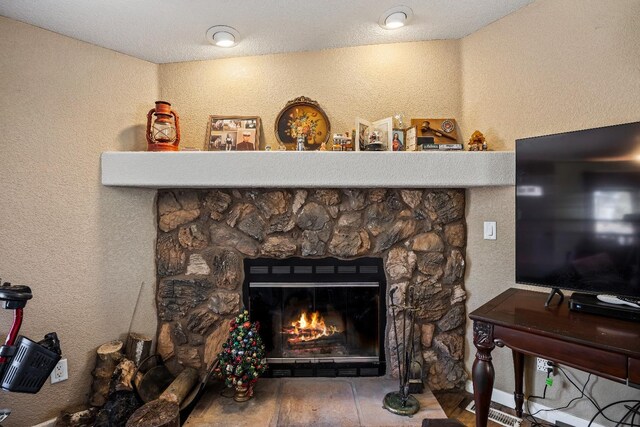 details featuring hardwood / wood-style flooring and a fireplace