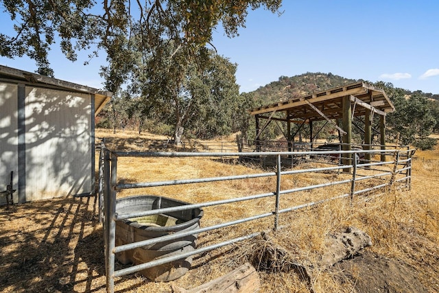 view of yard featuring an outdoor structure and a rural view