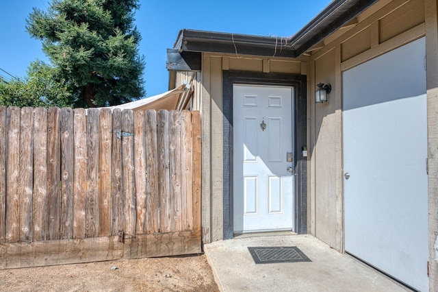 view of exterior entry with fence