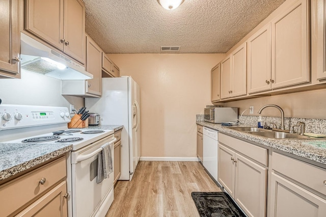 kitchen with under cabinet range hood, white appliances, a sink, visible vents, and light countertops