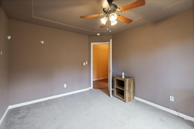 spare room featuring ceiling fan and light colored carpet