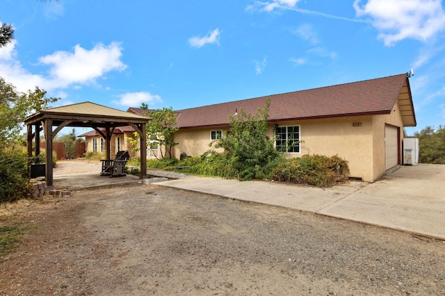 view of front of property with a gazebo and a garage