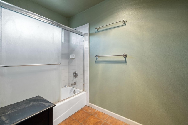 bathroom featuring tiled shower / bath and tile patterned flooring