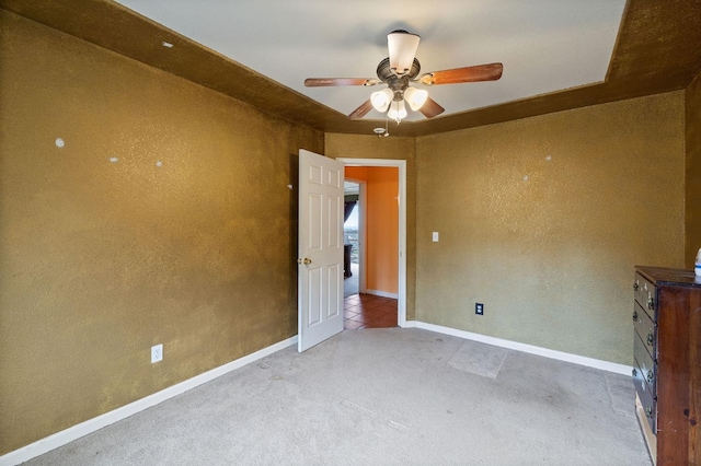 unfurnished room with carpet floors and ceiling fan