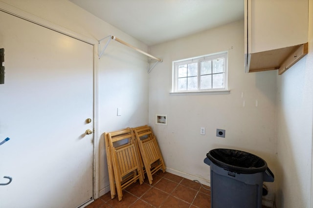 washroom featuring hookup for a washing machine, dark tile patterned flooring, and electric dryer hookup