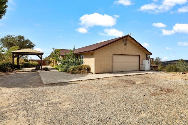 view of front facade featuring a gazebo and a garage