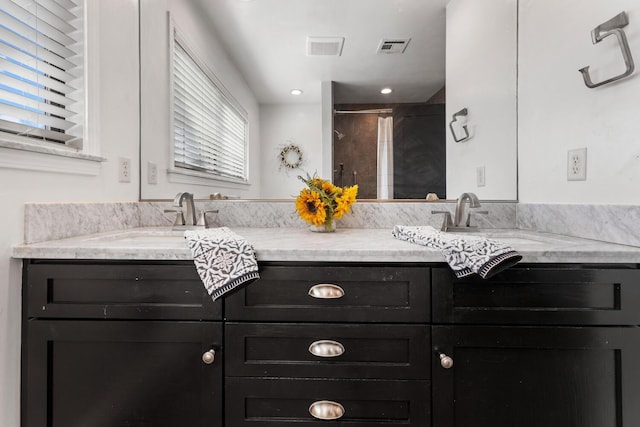 bathroom with vanity and walk in shower