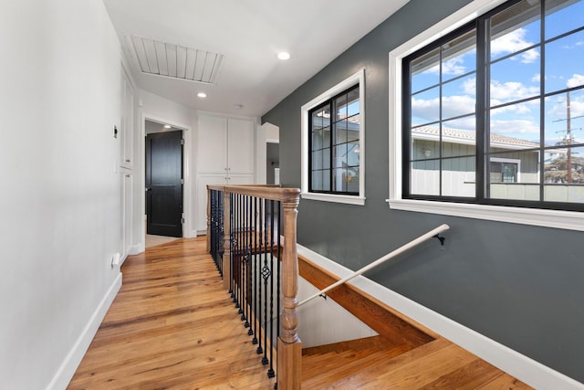 corridor with light hardwood / wood-style flooring