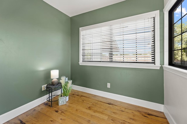 unfurnished room featuring hardwood / wood-style flooring