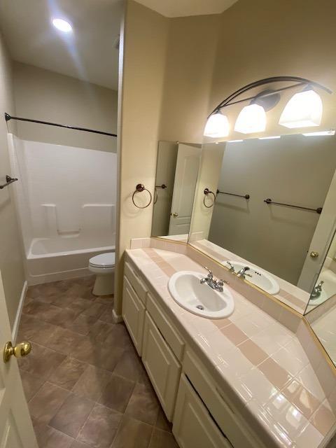 full bathroom featuring vanity, toilet, and shower / tub combination