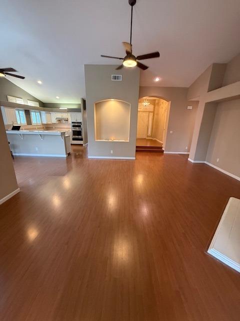 unfurnished living room featuring dark hardwood / wood-style floors and ceiling fan