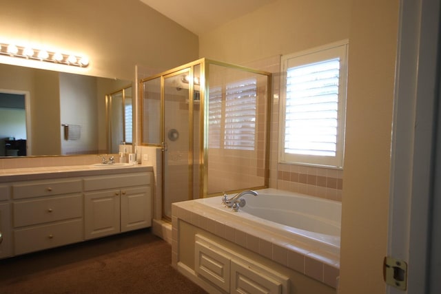 bathroom with vanity and independent shower and bath