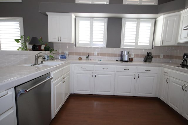 kitchen featuring decorative backsplash, dark hardwood / wood-style flooring, white cabinets, sink, and dishwasher