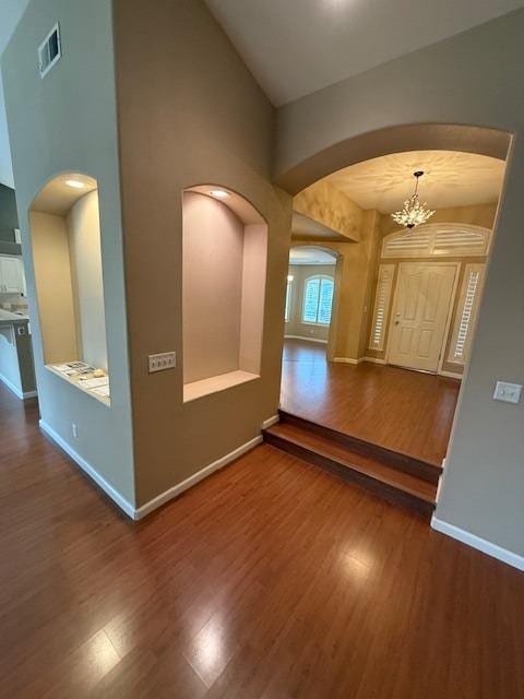 interior space featuring dark hardwood / wood-style flooring and an inviting chandelier