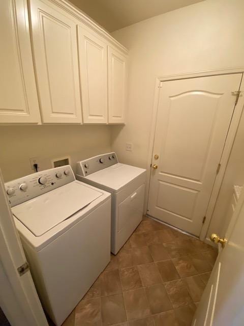 washroom featuring cabinets and independent washer and dryer