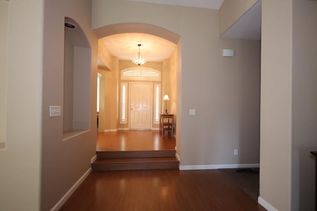 entrance foyer featuring dark wood-type flooring and a chandelier